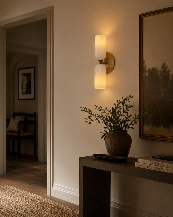 Sloane Double Cylinder Alabaster Wall Sconce installed in a modern hallway, providing warm ambient lighting with handcrafted alabaster shades and a solid brass finish.