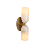 Three-quarter illuminated view of the Sloane Double Cylinder Alabaster Wall Sconce highlighting the translucent natural alabaster shades.