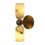 Illuminated view of the Sloane Dual Alabaster Cylinder Wall Sconce displaying the warm glow and distinctive natural veining of genuine alabaster shades.