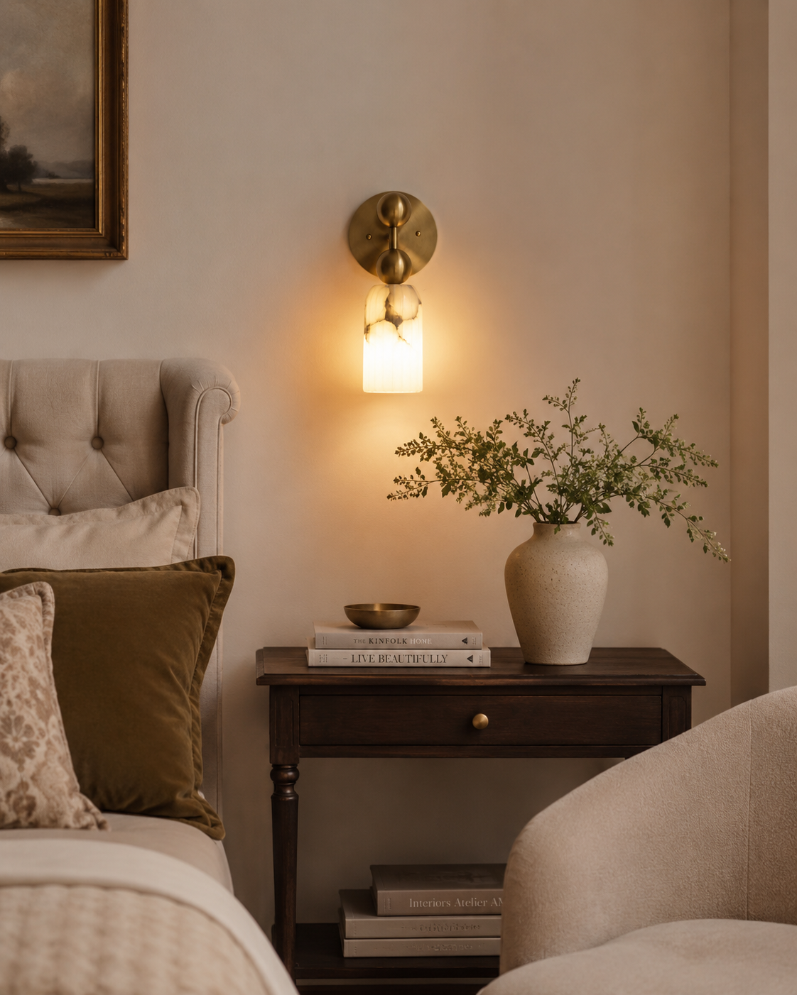Sloane Fluted Alabaster Wall Sconce installed beside a bedside table in a contemporary bedroom, providing warm ambient lighting with its handcrafted fluted alabaster shade and brass globe accents.