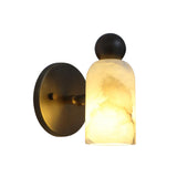 Angled illuminated view of the Sloane Rounded Alabaster Wall Sconce displaying warm ambient lighting and the unique natural alabaster veining.