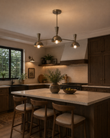 Soho 3 light brass dome chandelier positioned above a contemporary kitchen island with warm wood cabinetry and ambient lighting.