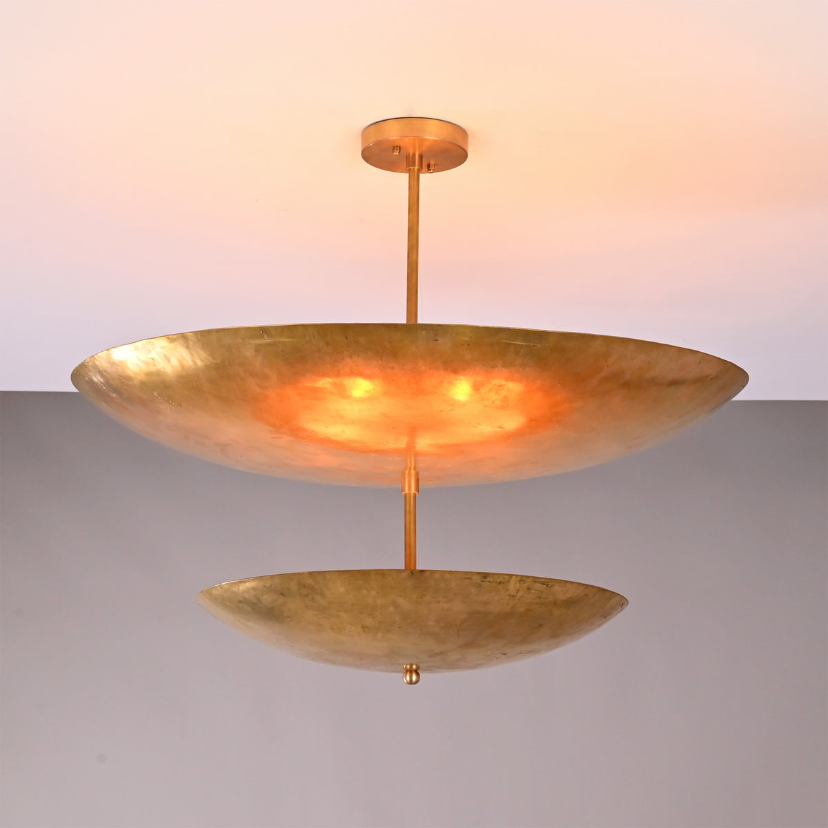 Front view of Solara Double Saucer Pendant Light with two layered saucer shades and warm glow.