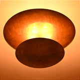 Close up of Solara Double Saucer Pendant Light highlighting warm diffused light between layered shades.