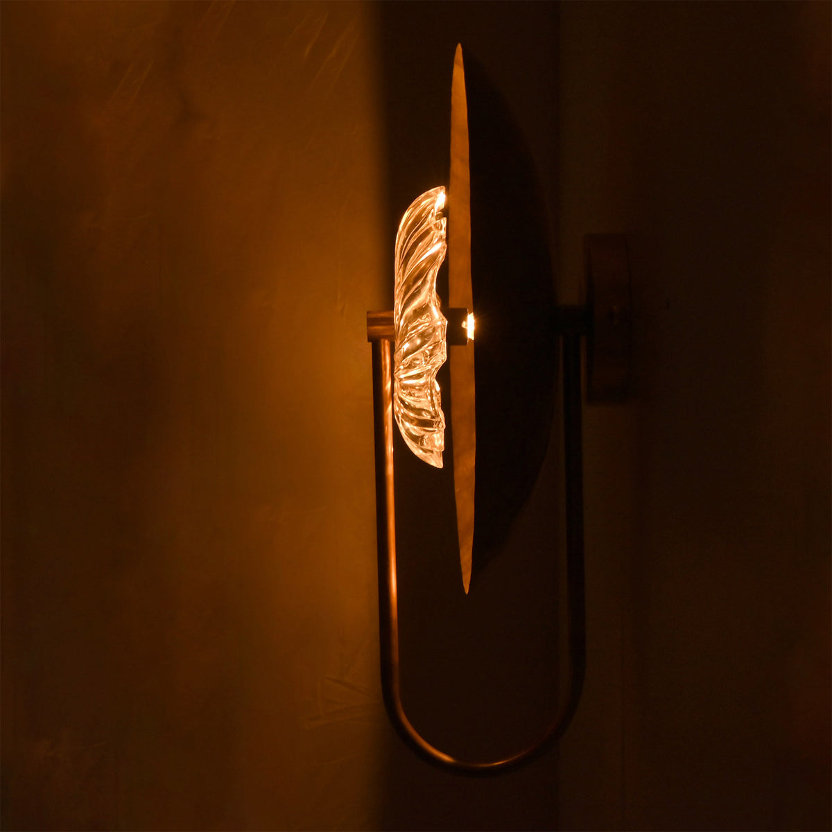 Side view of Solara halo glass disc wall sconce showing layered disc profile and clear sculptural glass detail.