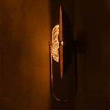 Side view of Solara halo glass disc wall sconce showing layered disc profile and clear sculptural glass detail.