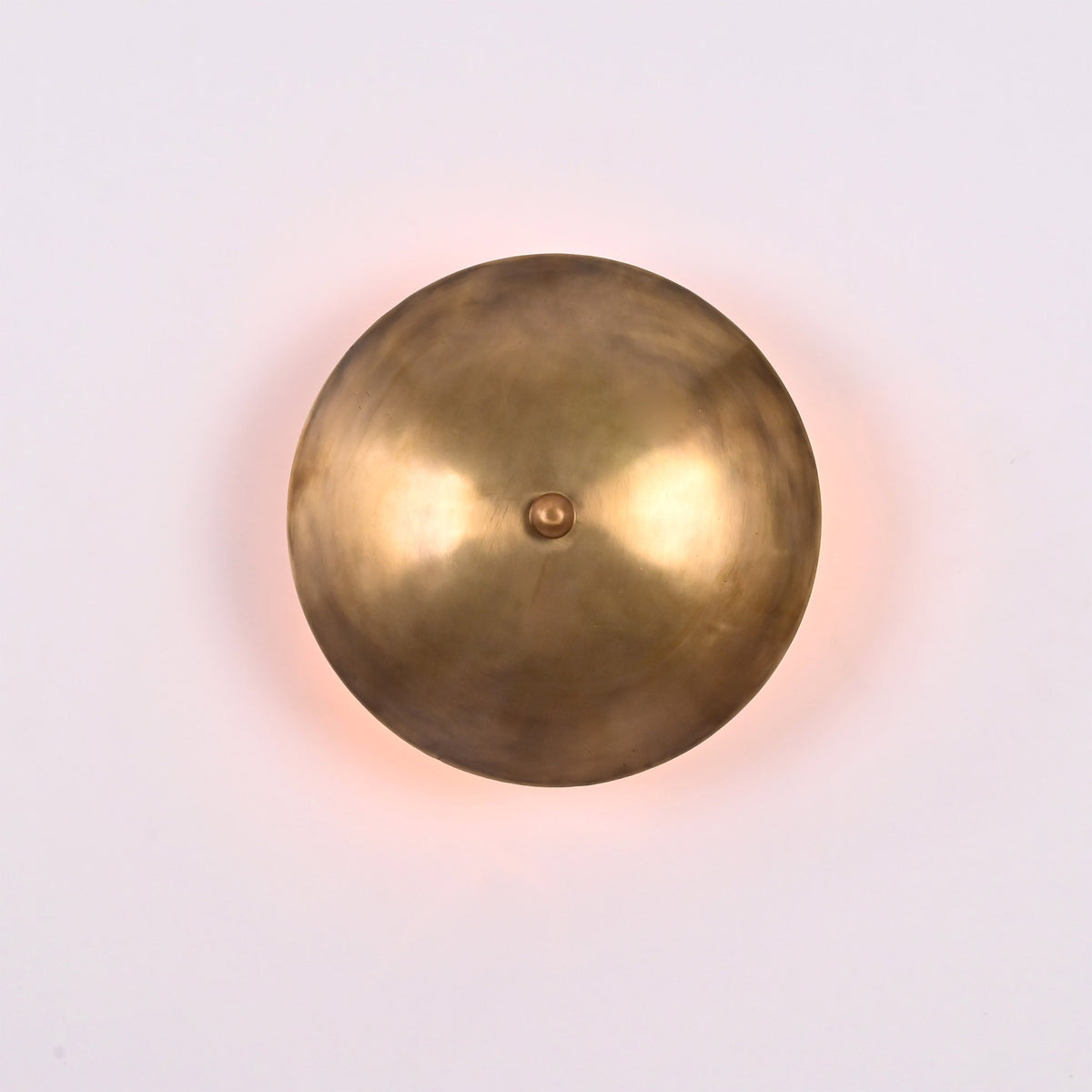 Front view of Solene Shield Wall Sconce with rounded shield disc and central decorative finial.