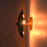 Side view of Solene Shield Wall Sconce showing hidden bulbs, wall canopy, and warm indirect illumination.