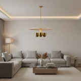 Sonoma 4 light sculptural disc chandelier shown from the front with a shallow cream shade, clustered brass-tone light cups, and streamlined downrod.