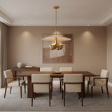 Sonoma 4 light Mid-Century Modern chandelier shown from a lower angled view highlighting the broad cream disc and sculptural brass-tone bowl lights.