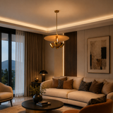 Sonoma 4 light cream disc chandelier displayed in a warm contemporary living room with brass-tone details and ambient illumination.