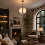 Stockholm 4 light white metal split dome chandelier illuminated in an elegant modern living room with warm ambient lighting.