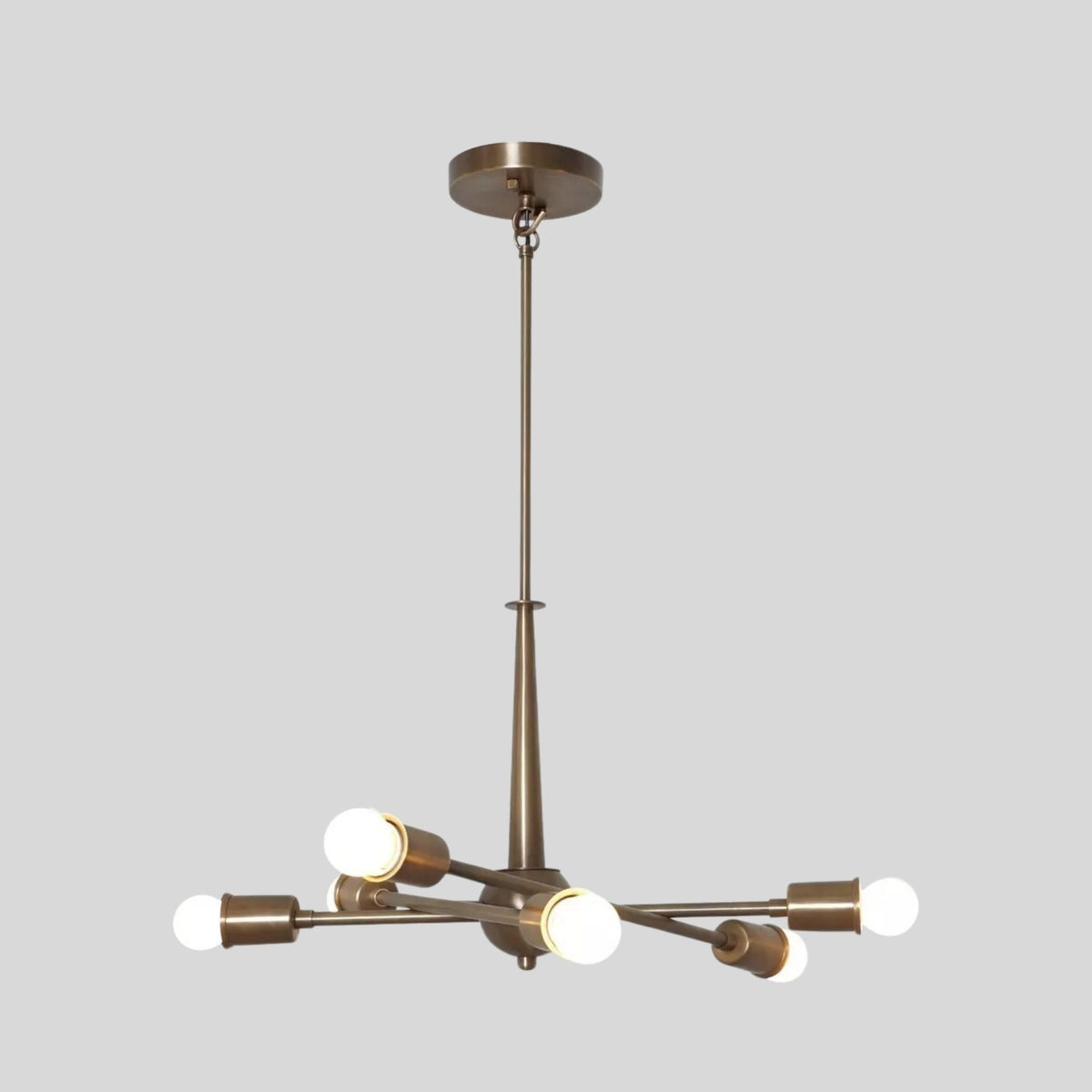 Lower angled view of Strasbourg 6 light chandelier with intersecting brass-tone arms and minimalist exposed globe bulbs.