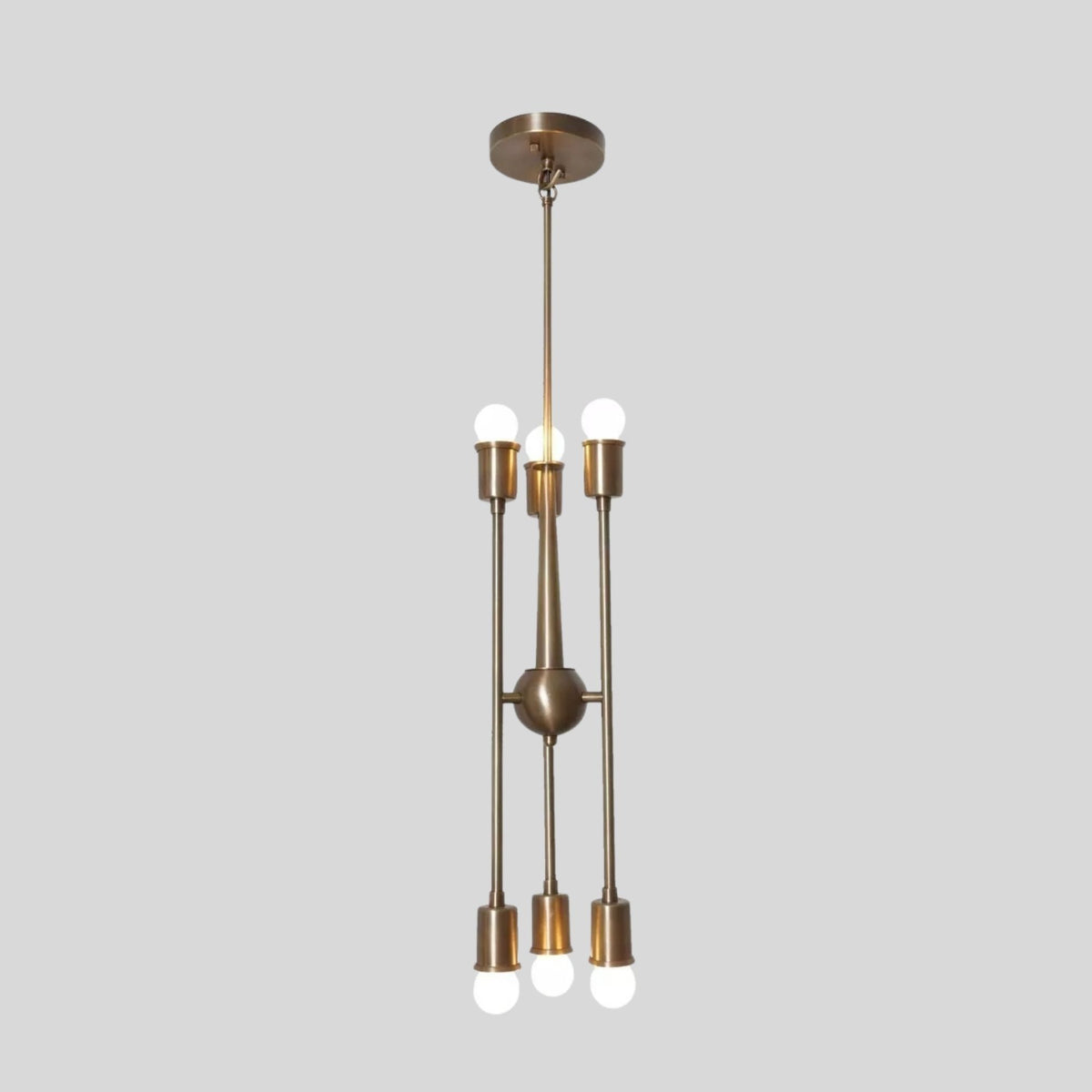 Side view of Strasbourg 6 light antique brass chandelier showing its sculptural multi-arm profile and exposed bulbs.