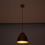 Hanging Sutton hammered bell pendant light with handcrafted copper shade and adjustable cord, providing warm task and ambient illumination.