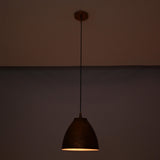 Close-up detail of the handcrafted hammered copper bell shade featuring an artisan textured finish and elegant curved silhouette.