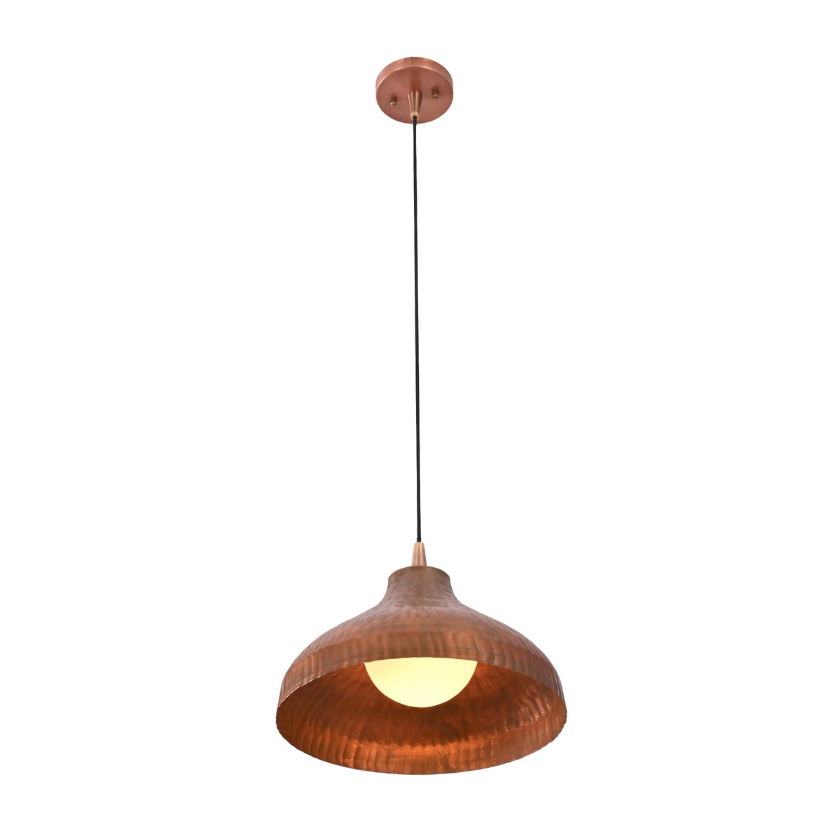Sutton hammered copper dome pendant light illuminated with warm ambient glow and exposed globe bulb.