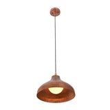 Sutton hammered copper dome pendant light illuminated with warm ambient glow and exposed globe bulb.