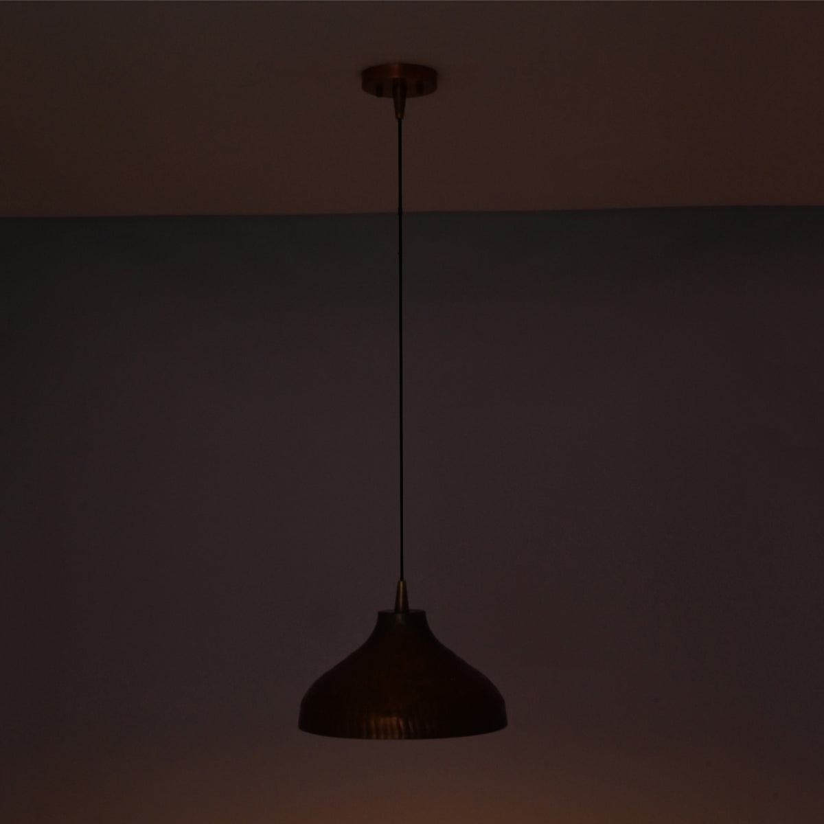 Unlit Sutton hammered copper dome pendant light highlighting its handcrafted silhouette and rustic finish.