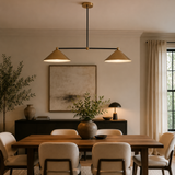 Sutton 2 light linear cone chandelier installed above a wooden dining table in a modern dining room interior
