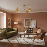 Sutton 38 inch brass linear chandelier with three tapered cone shades, left angled view