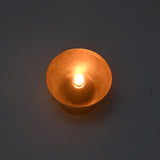 Illuminated close-up of the Sutton Modern Dome Wall Sconce producing a warm ambient glow from the exposed bulb within the dome shade.