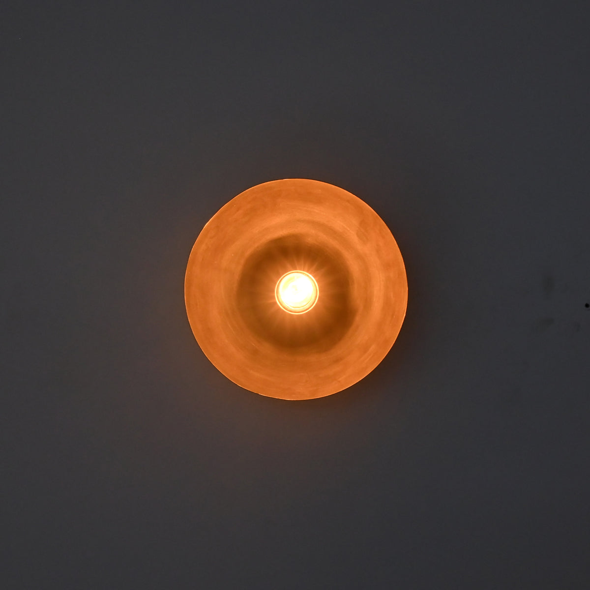 Front-facing illuminated view of the Sutton Modern Dome Wall Sconce emphasizing symmetrical light distribution and architectural form.