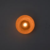 Front-facing illuminated view of the Sutton Modern Dome Wall Sconce emphasizing symmetrical light distribution and architectural form.