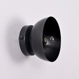 Perspective detail of the Sutton Modern Dome Wall Sconce highlighting the smooth handcrafted dome shade and exposed bulb socket.