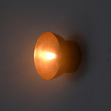 Side illuminated view of the Sutton Modern Dome Wall Sconce highlighting the sculptural dome profile and warm accent lighting.
