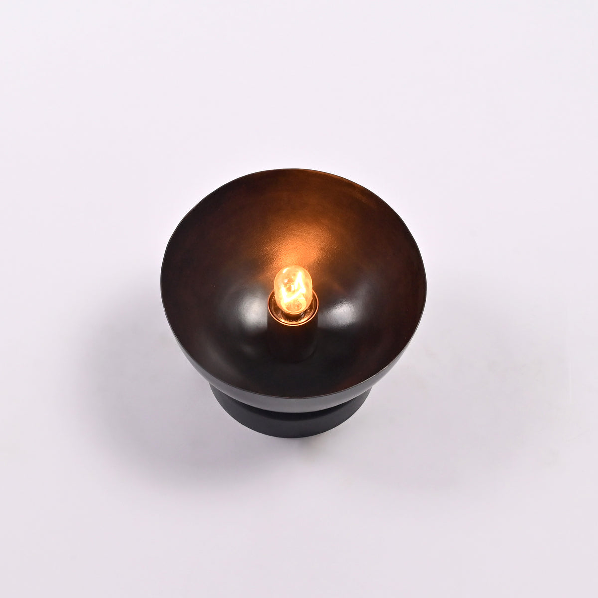 Top view of the Sutton Modern Dome Wall Sconce showcasing the exposed bulb centered within the handcrafted dome reflector.