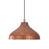 Close-up of handcrafted hammered copper dome shade showcasing artisan texture and warm metallic finish.