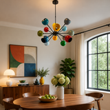 Tallinn 12 light multicolor Sputnik chandelier displayed above a wooden dining table in a bright Mid-Century Modern dining room.