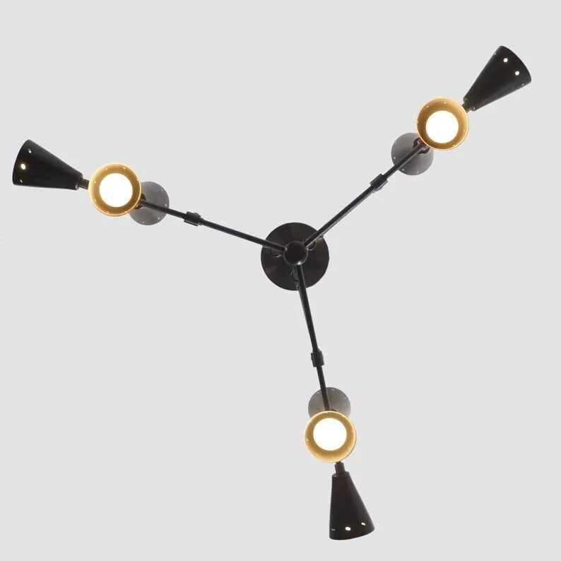 Bottom view of the Taormina 9-light Mid-Century Modern chandelier showing its radial three-arm arrangement, black tapered cone holders, and illuminated circular openings.