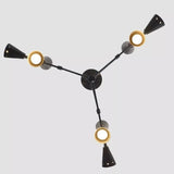 Bottom view of the Taormina 9-light Mid-Century Modern chandelier showing its radial three-arm arrangement, black tapered cone holders, and illuminated circular openings.