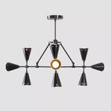 Taormina 9-light black industrial chandelier illuminated against a neutral background, showcasing its geometric multi-arm design, tapered cone shades, and warm glowing light holders.