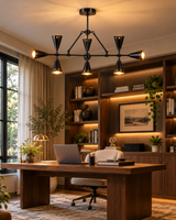 Taormina 9-light industrial black chandelier illuminating a sophisticated home office featuring a walnut desk, built-in wooden bookshelves, neutral furnishings, and warm contemporary lighting.
