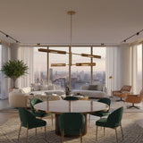 Taormina 4 light linear chandelier shown in a close-up angled view with elongated capsule-inspired metal shades and brass-tone frame.