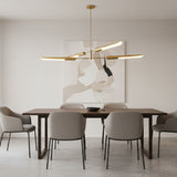 Taormina 4 light brass-tone linear chandelier shown from a front angled view with sculptural elongated metal shades.