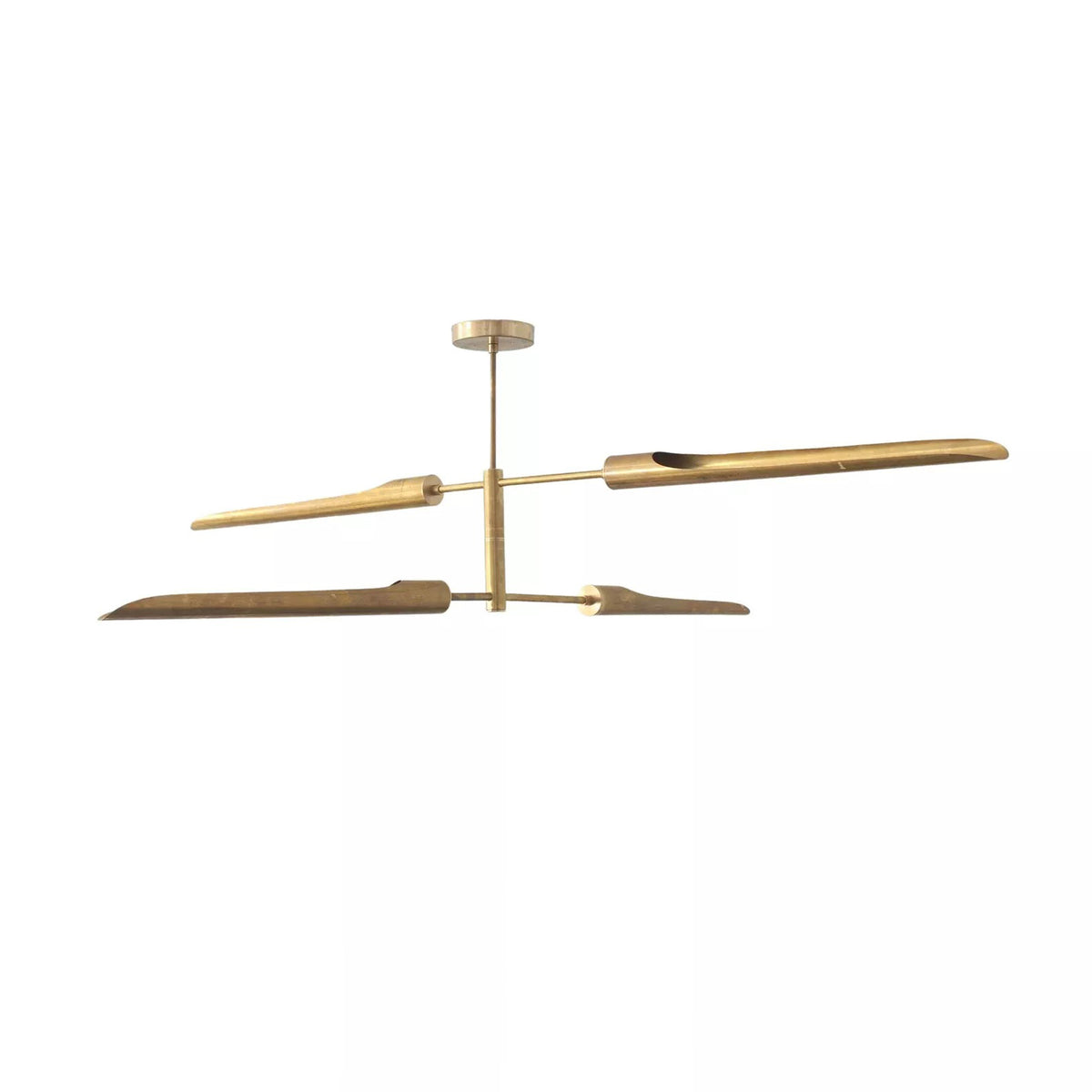 Taormina 4 light brass-tone linear chandelier shown from a side angled view highlighting its balanced two-level design.