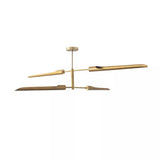 Taormina 4 light brass-tone linear chandelier shown from a side angled view highlighting its balanced two-level design.