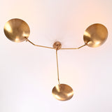 Overhead view of handcrafted three-light brass chandelier with curved bowl shades and brushed satin finish