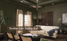 Brushed brass bowl chandelier in a sophisticated living room with earthy green walls, cream sofa, and flowing curtains.