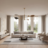 Tokyo 3 light counterbalance chandelier shown from an angled view with sculptural bowl shades, brass-tone arms, and spherical counterweights.
