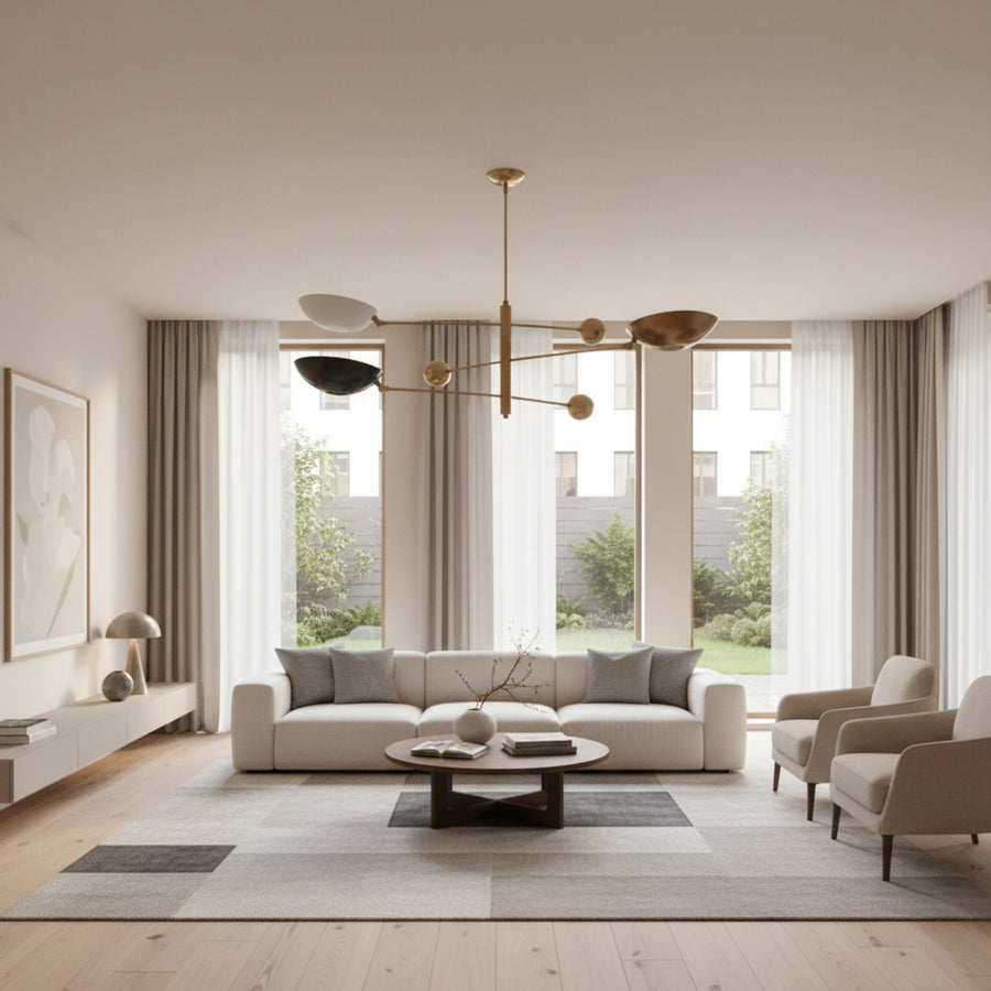 Tokyo 3 light counterbalance chandelier shown from an angled view with sculptural bowl shades, brass-tone arms, and spherical counterweights.