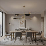 Tokyo 3 light counterbalance chandelier shown from a side angle highlighting its bowl shades, spherical weights, and asymmetrical brass-tone frame.