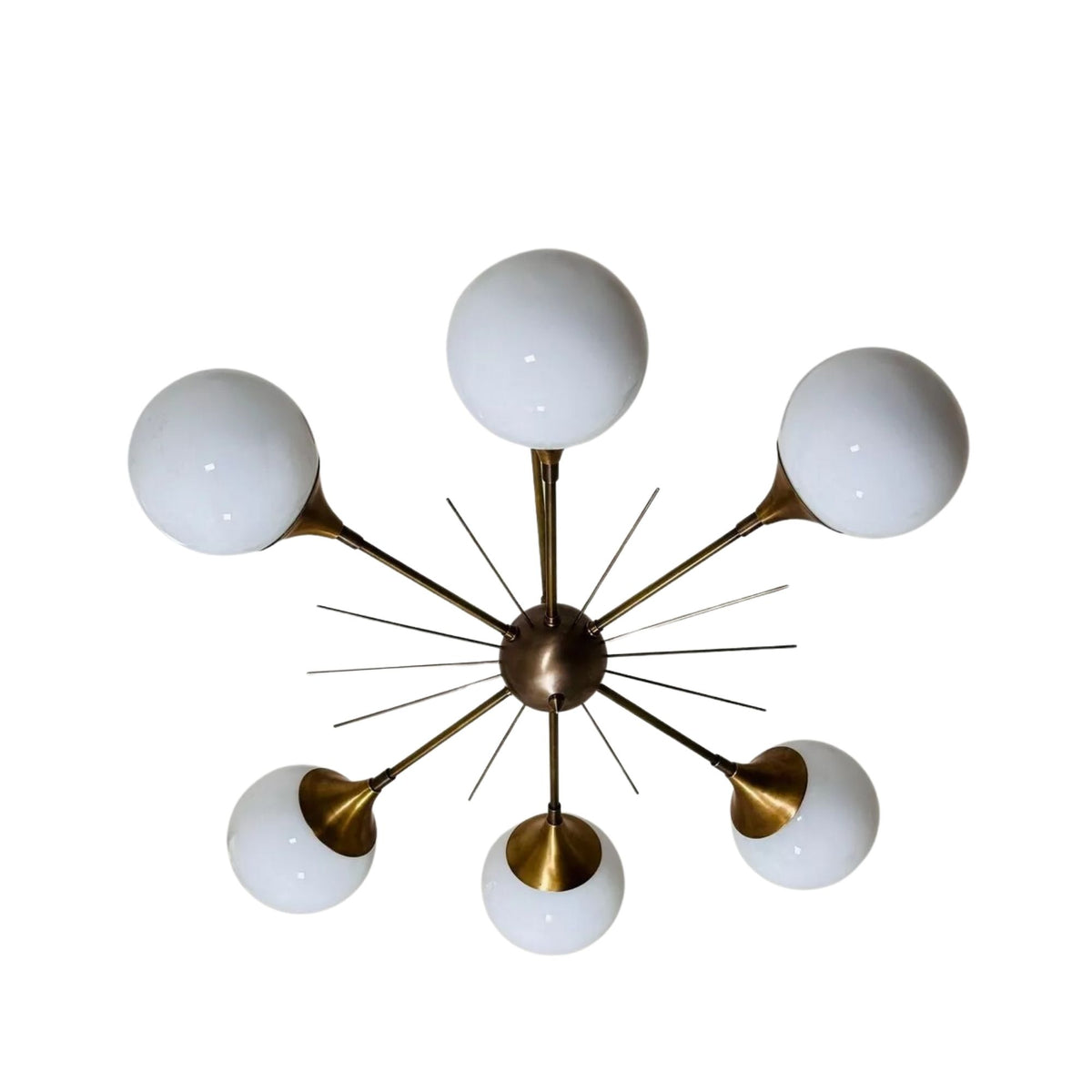 Toledo 6 light sculptural globe chandelier shown from below with six opal glass globes arranged around a brass-tone starburst central hub.
