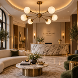 Toledo 6 light starburst globe chandelier with illuminated opal shades displayed in an elegant contemporary hotel lobby.