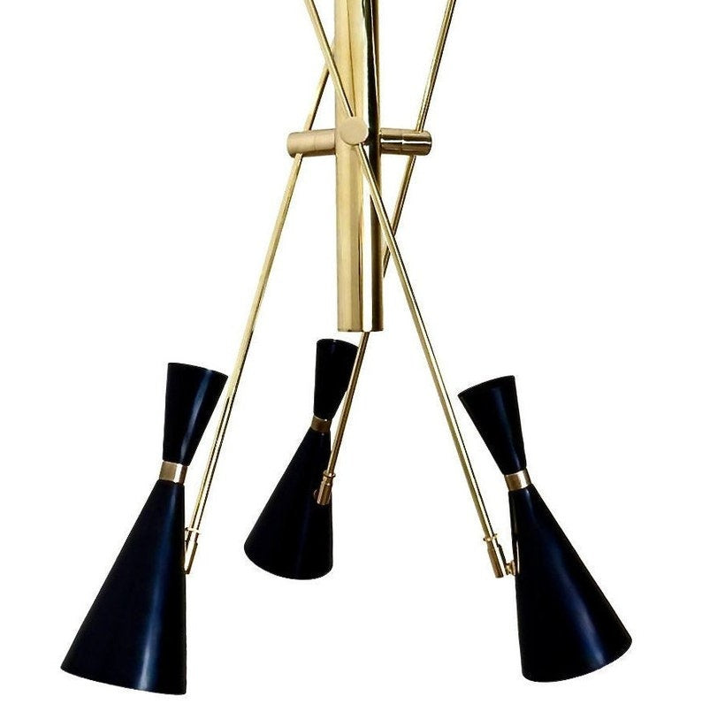 Close-up view of the Turin 3-light Mid-Century Modern chandelier featuring matte-black double-cone shades, brass-tone accents, slender angular arms, and a sculptural central metal structure.