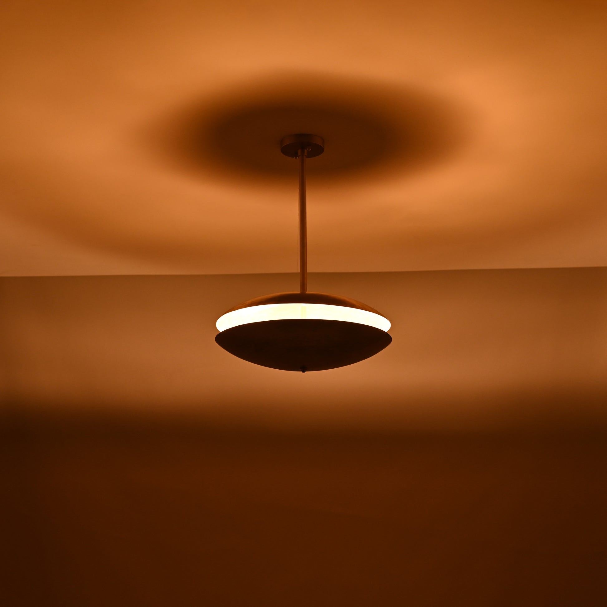 Warm brass pendant chandelier featuring balanced double domes